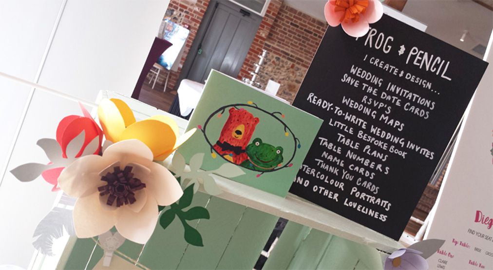 Close up shot of the Frog & Pencil stand at the Oxnead Wedding Show