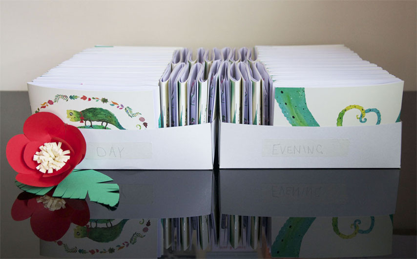 Abi & Rob Little Bespoke Book Wedding Invitations stacked in boxes.